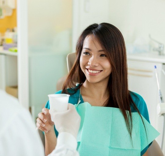 Woman smiling at dental team member in Honolulu dental office