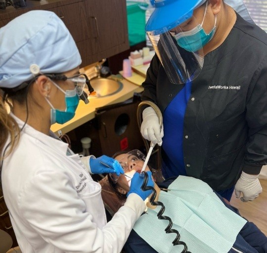 Two Honolulu dentists treating a patient