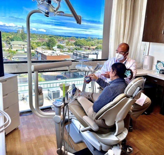 Dentist showing a model of a smile to a patient