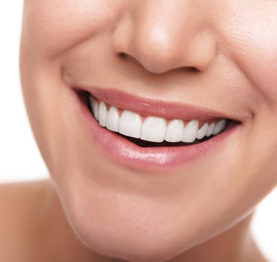 Close up of person smiling with flawless teeth