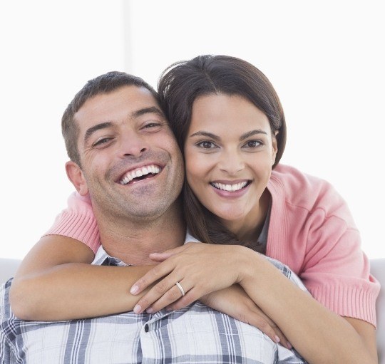 Young man and woman smiling with dental implants in Honolulu