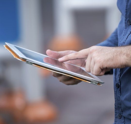 Person typing on a tablet