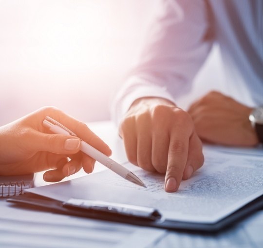 Two people looking at paper on clipboard