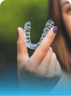 Person holding an Invisalign clear aligner