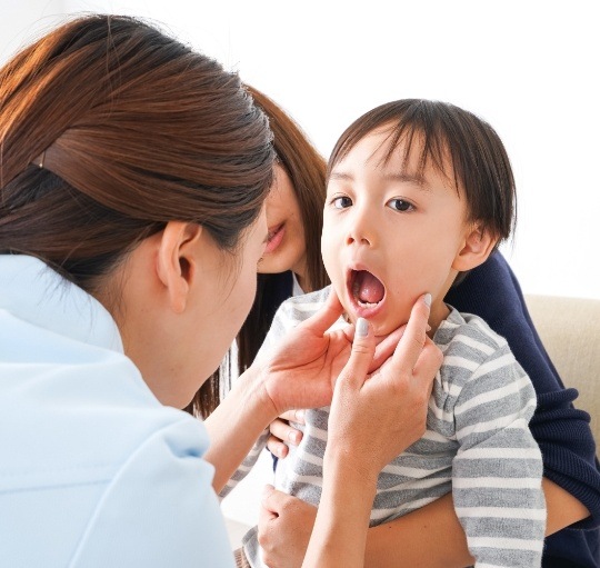 Dentist giving a child a dental exam